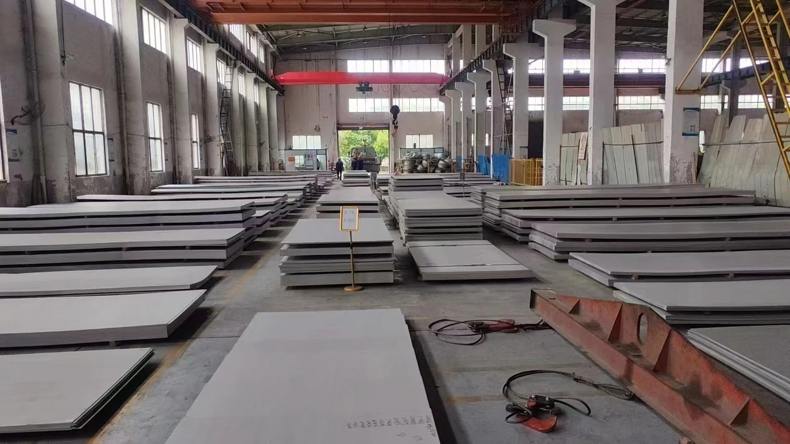 Stainless steel plate stock arranged in a workshop